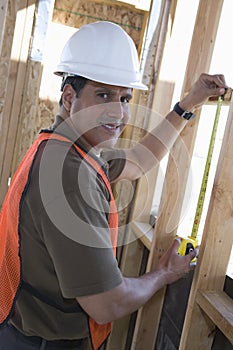 Architect Measuring Window At Site