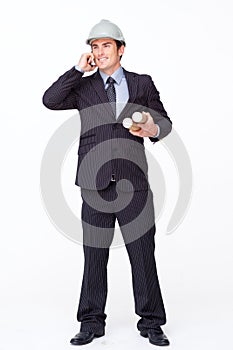 Architect on mobile phone holding plans