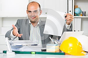 Architect in office keeping keys in the hand