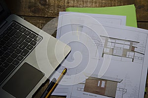 architect plans and notebook on wooden table