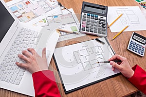 Architect`s hands with house plan, calculator