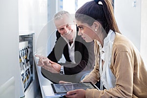 Architect Showing Heating System To Assistant In Construction Site