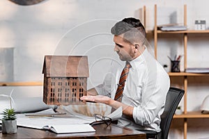 architect sitting at workplace and pointing