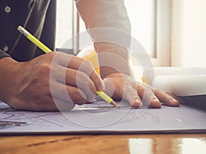 Architect sketching a construction project blueprint