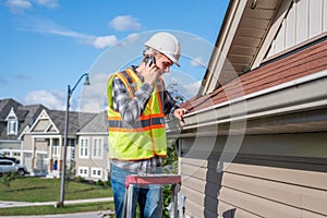 Architect standing on a ladder.