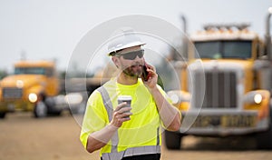 architect supervisor or construction engineer man talking on phone at building site