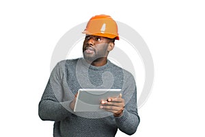 Architect with tablet looking on building.