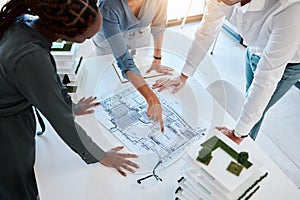 Architect, team and planning building blueprint in office for coworkers to look at before construction. Workers looking