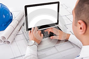 Architect using laptop in office