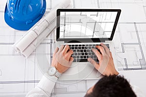 Architect using laptop in office
