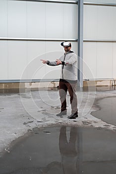 Architect with VR visor exploring industrial building environment