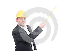 Architect wearing hardhat holding up measuring tape