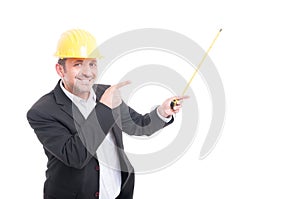 Architect wearing hardhat pointing up measuring tape