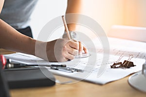 Architect work concept. Close up hand of architect writing on the blueprints in the office