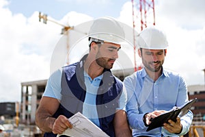 Architect and worker planning meeting on construction site