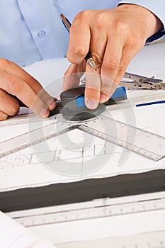 Architect working on architectural plans