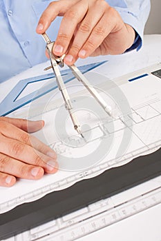 Architect working on architectural plans