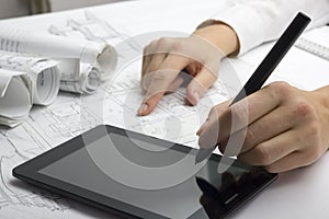 Architect working on blueprint. Architects workplace - architectural project, blueprints, ruler, calculator, laptop and