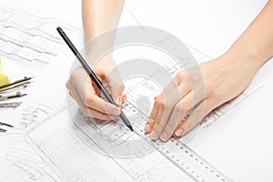 Architect working on blueprint. Architects workplace - architectural project, blueprints, ruler, calculator, laptop and