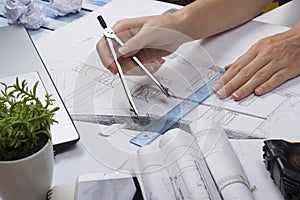 Architect working on blueprint. Architects workplace - architectural project, blueprints, ruler, calculator, laptop and