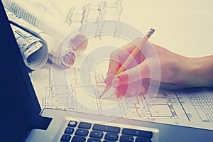 Architect working on blueprint. Architects