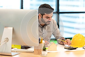 Architect working on blueprint. Architects workplace. Engineer tools and safety control, blueprints, ruler, orange helmet,radio,la photo