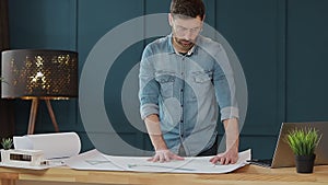 Architect working on blueprint with spesial tools and pencil, close up. Male architect at work, only hands with ruler