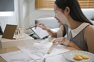 Architect working with computer tablet at home.