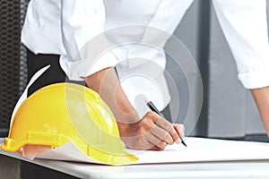 Architect working with construction tools and helmet safety on table