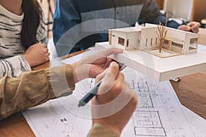 An architect working and discussing about an architecture model