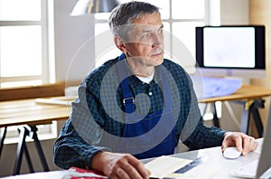 Architect working on drawing table in office