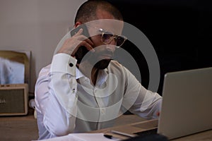 Architect working at his laptop in a home office