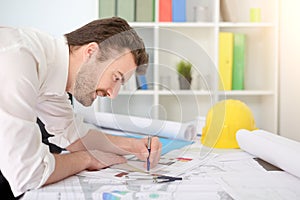 Architect working on his projects paper in the office