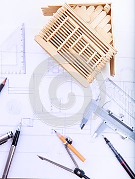 architect working table with plan home model and writing instrument and paper work