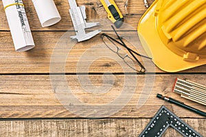 Architect workplace. Project construction blueprints and engineering tools on wooden desk, copy space