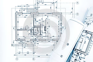 Architect workplace with project plans and rolled blueprints