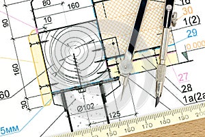 Architect workspace with blueprint and drawing compass closeup