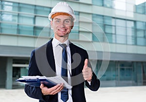 Architector in suit and hat is satisfied with realisation his pr