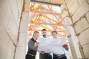 Architects and civil engineer at the construction site.