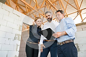 Architects and civil engineer at the construction site.