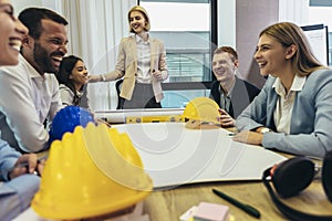 Architects, designers and engineers having working meeting in modern office