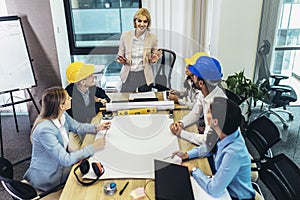 Architects, designers and engineers having working meeting in the office