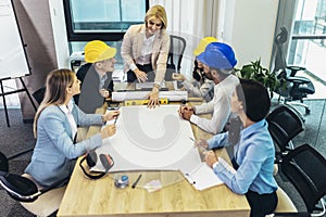 Architects, designers and engineers having working meeting in the office