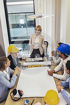 Architects, designers and engineers having working meeting in the office