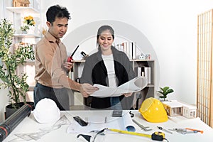 Architects Discussing Building Models and Blueprints