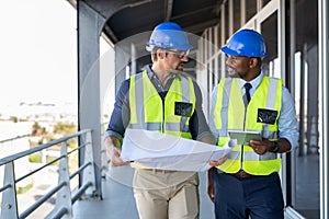 Architects discussing plan at construction site