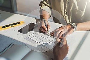 Architects or engineer construction discussing about interior design project with blueprints in architects workplace photo