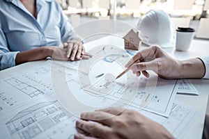Architects or engineering team consulting and analyzing working on objects tools and construction drawings inspection planning new