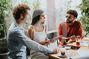 Architects, engineers, and executives discuss blueprints at a coffee bar, collaborating on a new urban planning project