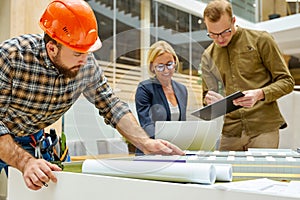 Architects and engineers working with blueprints and architectural plan